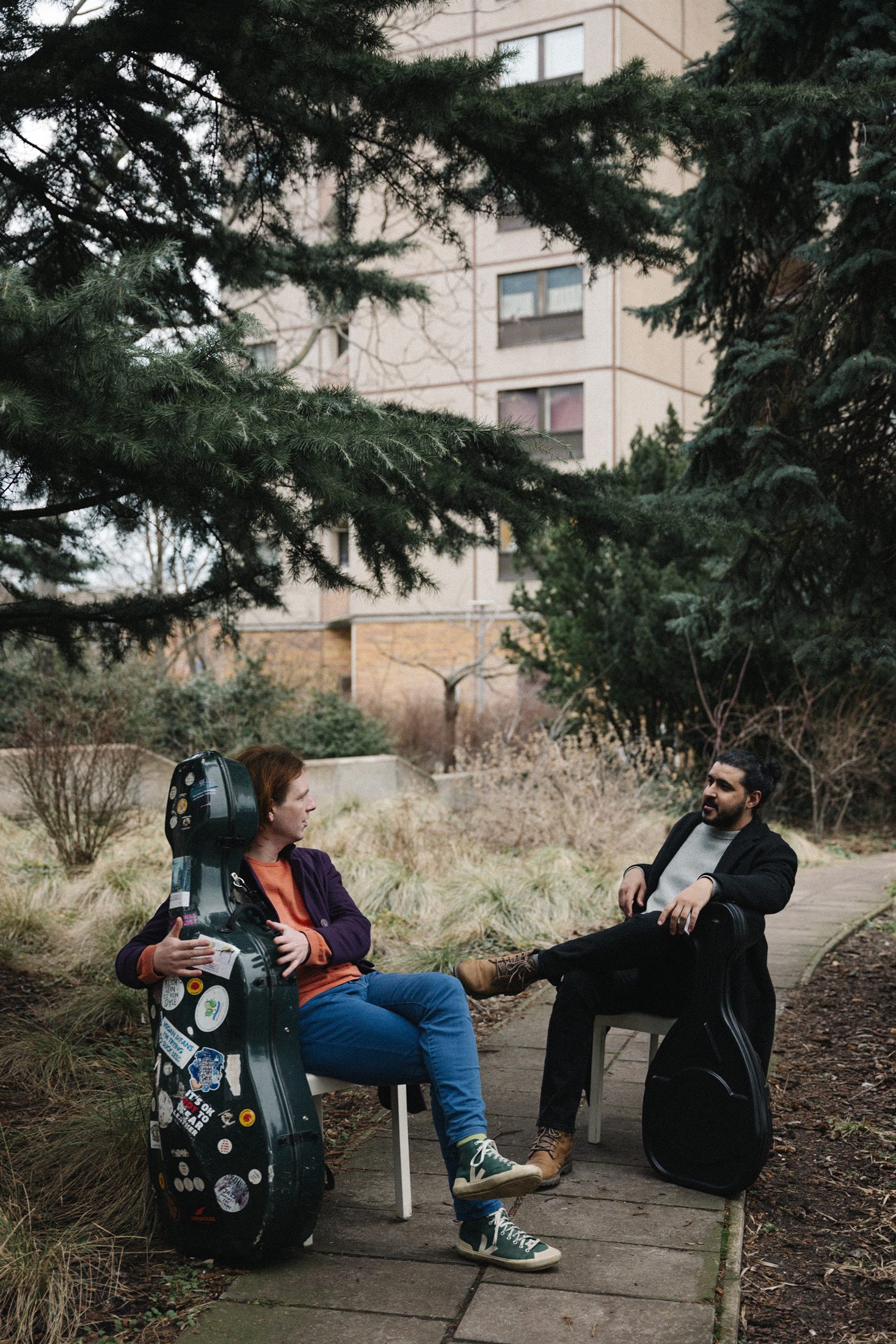 Sufian and Plush Rebel seated outdoors in color